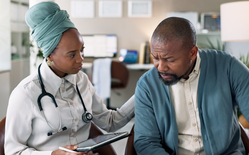 Doctor, tablet and comfort patient for healthcare, cancer diagnosis or bad news. Medical worker, te.