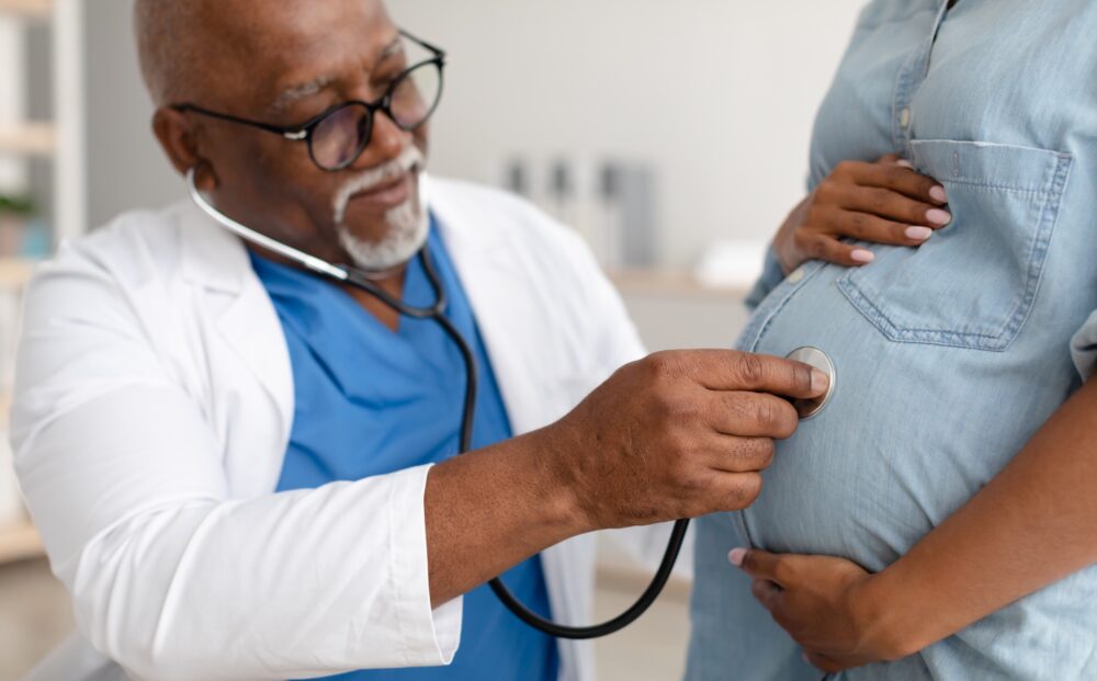 Gynecology Consultation. Closeup of black mature male gynaecologist examining pregnant female patient with stethoscope, doing medical check-up, lady hugging belly visiting doctor in maternity clinic SSUCv3H4sIAAAAAAAACoxWzY6jOBC+r7TvEHEetP7BBuYJ9jLS3EdzMMYEKwYjY7onavW7bwEhDXZ60zds1+9XXxX19vdfp1NSiVHL5PvpbT7BWRszjd4Jr20P1+jb7d6pvlZuf/PiKEf7C1Vrb50WZn9ZCS/bXnQKLvvJmPn6fXlMRi/8NKpx5x0T6ho407vNcYAjvlvT59FbeRla6+38sDMnhVdn8H8wuKX3az2ftoflETTgKfmp7GBU8m33Mk7V/PJDj1IZI3plpzHZ3ld/nxj7VwnjWymc+ucHACIBja8bXj9+b9mKs+rl9SOb2YtTUJoX1Ql3UX6f2IIeu9v6vX687wByyiix4n3TSvKKS0rqIq1F06RZLlFalFSlktUMl3lT5/gOTEIL2jQM8bQgCIRJU6WCsDyVvFZVjbgscLH4XxNILq9euW5fjREikHP4p8ZKSHwXfsIRZygJEWgcQNifgD/Lx1ED2MJDjS4QKjljOBSqjJCXoy2Cc/pRqYTQEpc4I6FmbSVwPAiDcRbKjarXoVxOeBTJq30QcBHhUAFZrgexnGJESRkKDsAO1fsgQBoH6NV4lMIIMR7B6We+dZFFxAiNXDt17sVK2INzVERFmjsjEOPlZxb9c4OjV761o7SDCoQh98hse4WhoCM2PSjjEqjuA6Moy9mOKw/RaO9z4DlyslXyMg3H+mJcROG8Wuj6kH00j+A4X3uhpDX2fCwGRpyzLHIfB4my8oHN1aSOiPPQqO3HyfjtP/IkMajdoP3y59iFwRiJildp59sg2jIWU3+GedL05+fcWSt1lOOI7qfBWrWPM6RQxk1qRH193srgzvkKuuogShgq8uxBA/QiguVREqqrnJBxvryMAoCfinLCnAZQ8HquT0QpxvNQy1Zzj7m4b/ICxYy+k+Ur/LNNo2XIQI4jBhpgHozVOMcsZp/RfTBh8gLzKM5GOa+N9sHM4llctxc96mPNipLHTL7aKQwwJyyu1x/RPW+LSlTXyFaUrBgGq/t4Sj802VnfRvUuUAR2B9uU6yNkHg9f+InJYwdhBC2CPp9LXxwirTZ1BMA9p91uI6Za292m8WJh85oXDLoTGmb6LtV5u91sYGxqEqrn3ZxzQoCAd+ZZO4gKdsTvpwbMqnsvi3EEjXq73/mC9QZg2bnqLfxyZ8Or1aQGgOcjhr84gjbNCpJjBrjhZL8et4CUXSLaYpwGY0Wt6sNeiG+LMzQDrDIZo8XHtLrt0MsLI2RbzZdhGqzTq0zOF9Q+Nt15be209//rlFO8rOPHpXOxr+tHS37SaXOxI0REESJspeBNTc+eklJWIueKphJySjMqq7SsSZliUjPoPl5IXoHW+38AAAD//wMAKH4g9MsMAAA=